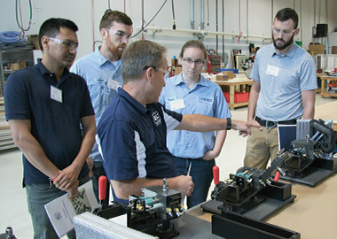 Image of CTS employees training on leak testing equipment