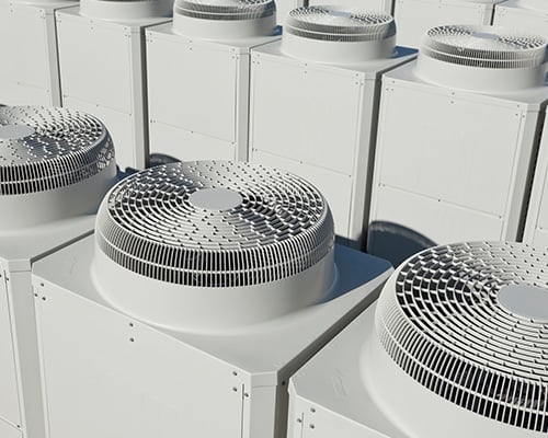 Close-up of commercial heating and cooling systems on the rooftop of a building. 