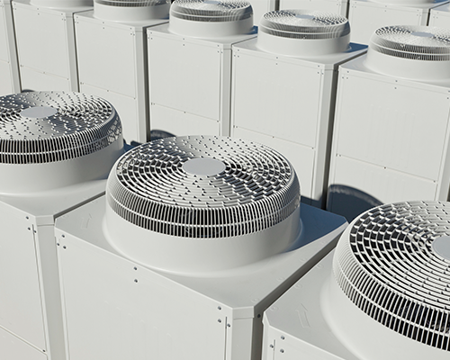 Close-up of commercial heating and cooling systems on the rooftop of a building.