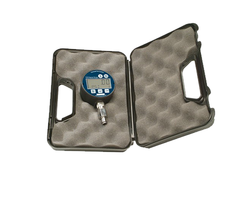 Image shows vacuum/pressure gage with digital screen showing 0.0, on the left side inside an open padded case.