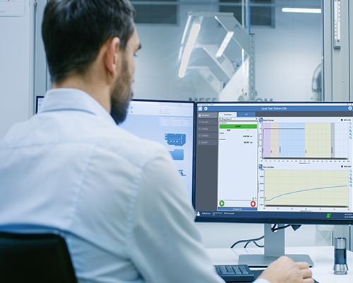 Man in industrial office facing computer monitor which has a CTSnet LT screen on it.