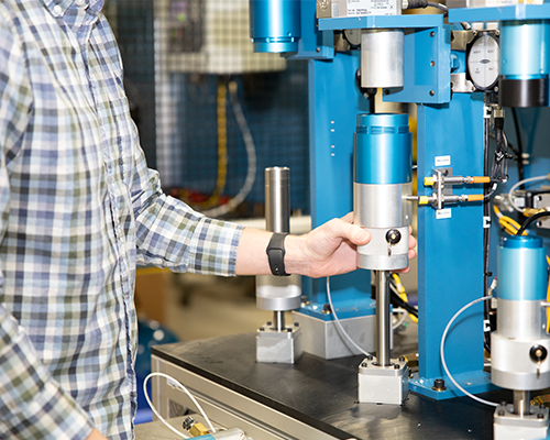  Image shows person with hand positioning a CTS Connect on a leak test station 